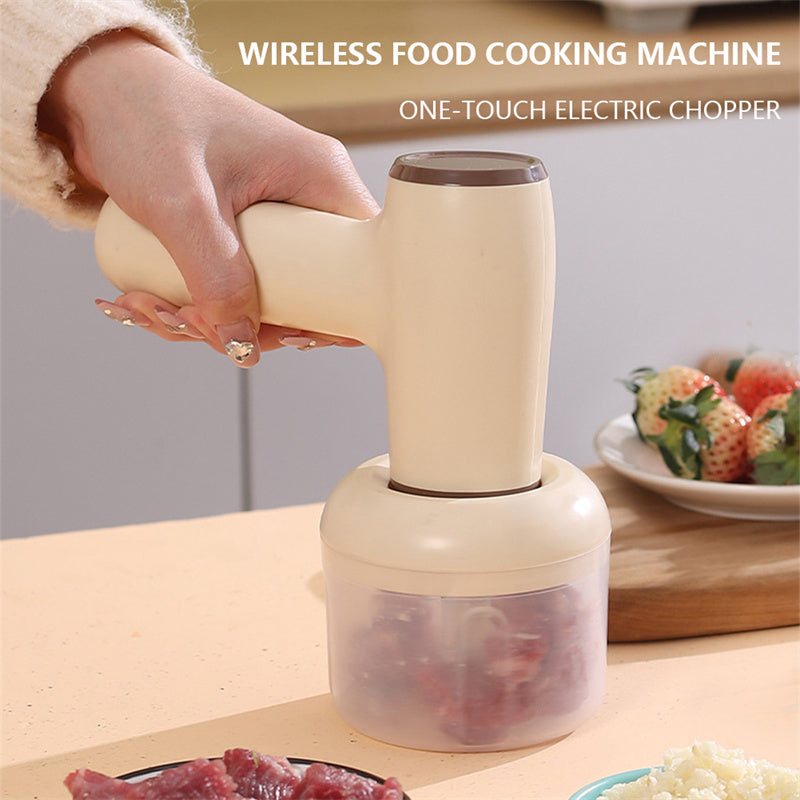 Beige handheld one-touch food chopper with clear cup and chopped ingredients