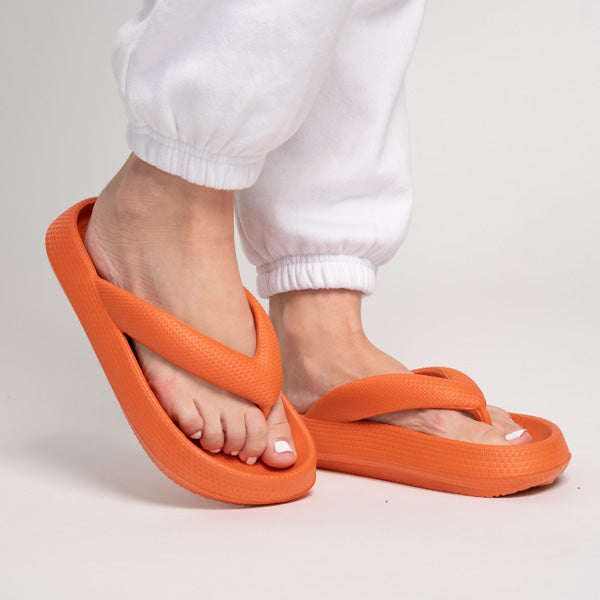 Orange thick-bottom flip flops with wide thong straps