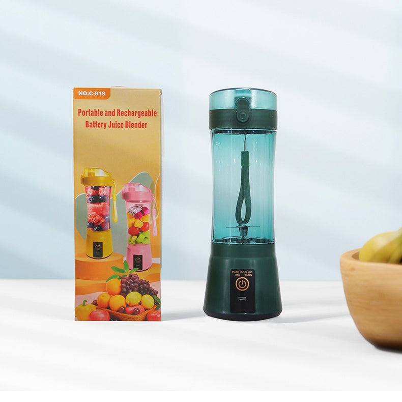Green portable electric fruit juicer with clear blending cup and USB charging base