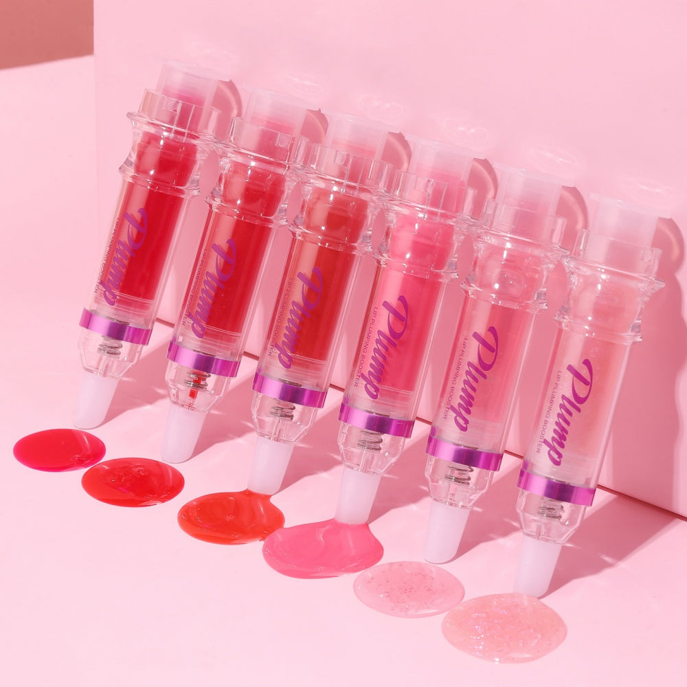 Set of lip plumping booster lip gloss tubes with clear caps and pink, red, and purple shades