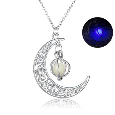 Silver crescent moon pendant necklace with glowing purple stone on a chain