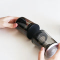Handheld Bluetooth speaker with transparent outer shell and black end caps