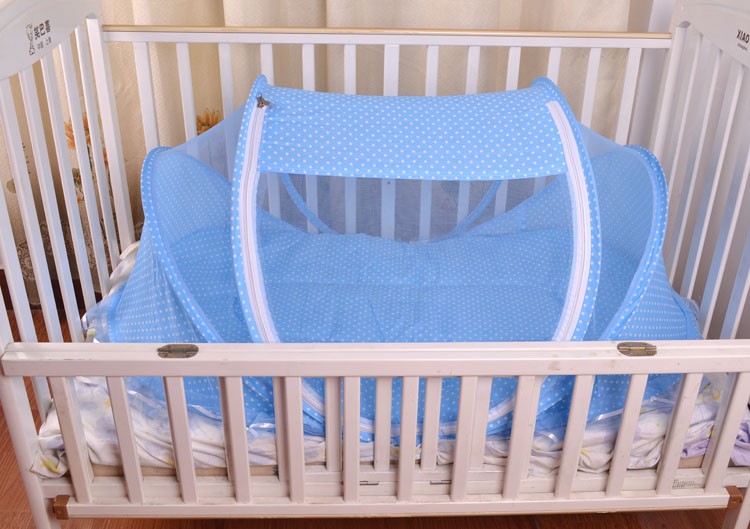 Foldable baby bed net set in blue, arched mesh canopy with white trim on a crib