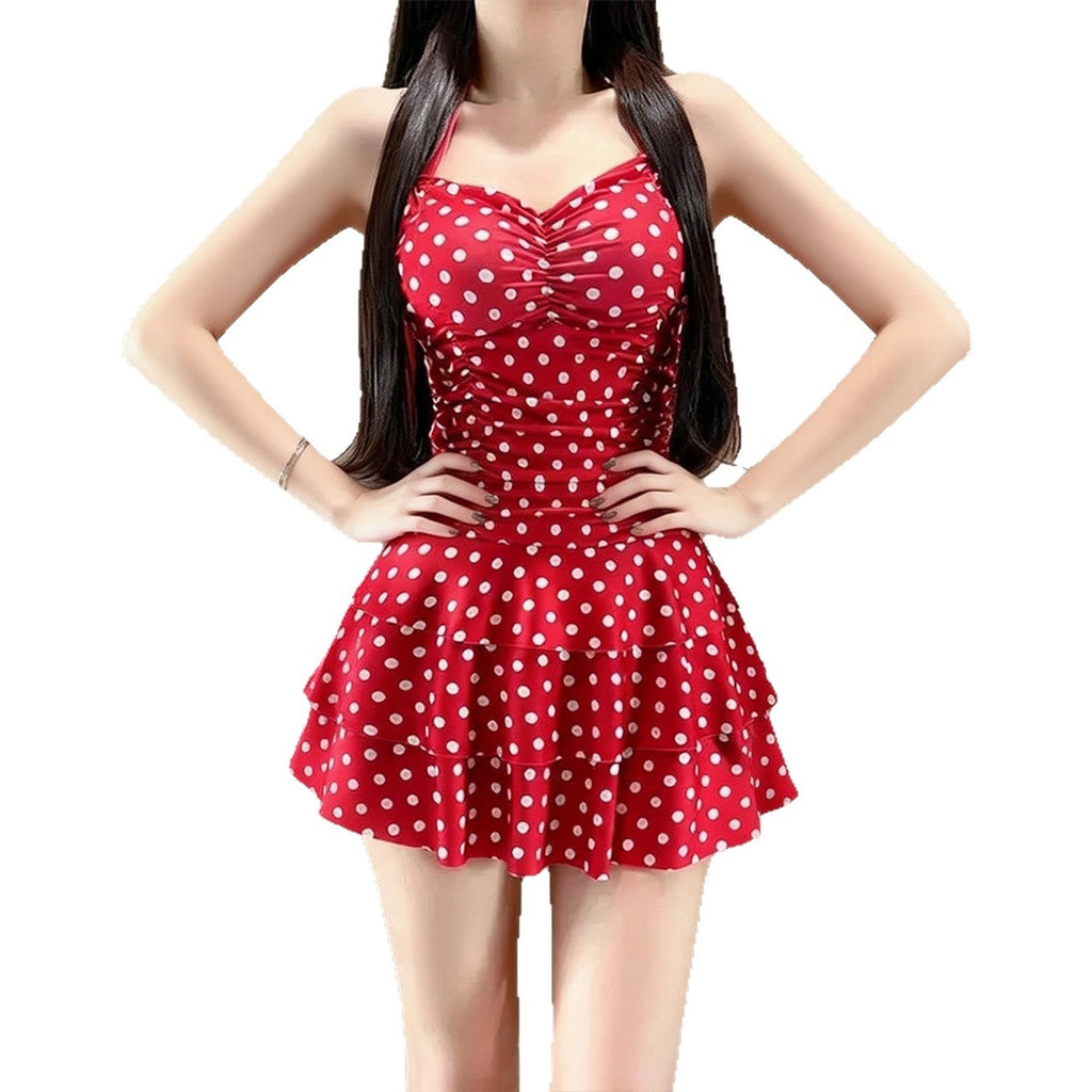 Red polka-dot one-piece swimsuit with ruched bust and ruffled waist skirt
