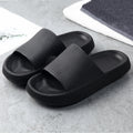 Black slide slippers with textured wide straps and cushioned sole