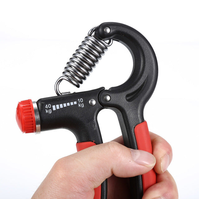 Finger exerciser hand grip close-up: black body, red handle grips, metal spring