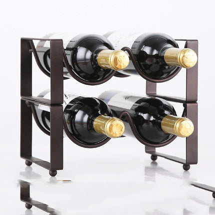 Two-tier black metal wine bottle rack with four curved slots, holding four bottles