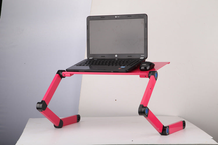 Rose pink folding laptop stand with adjustable arms, holding a laptop on tabletop
