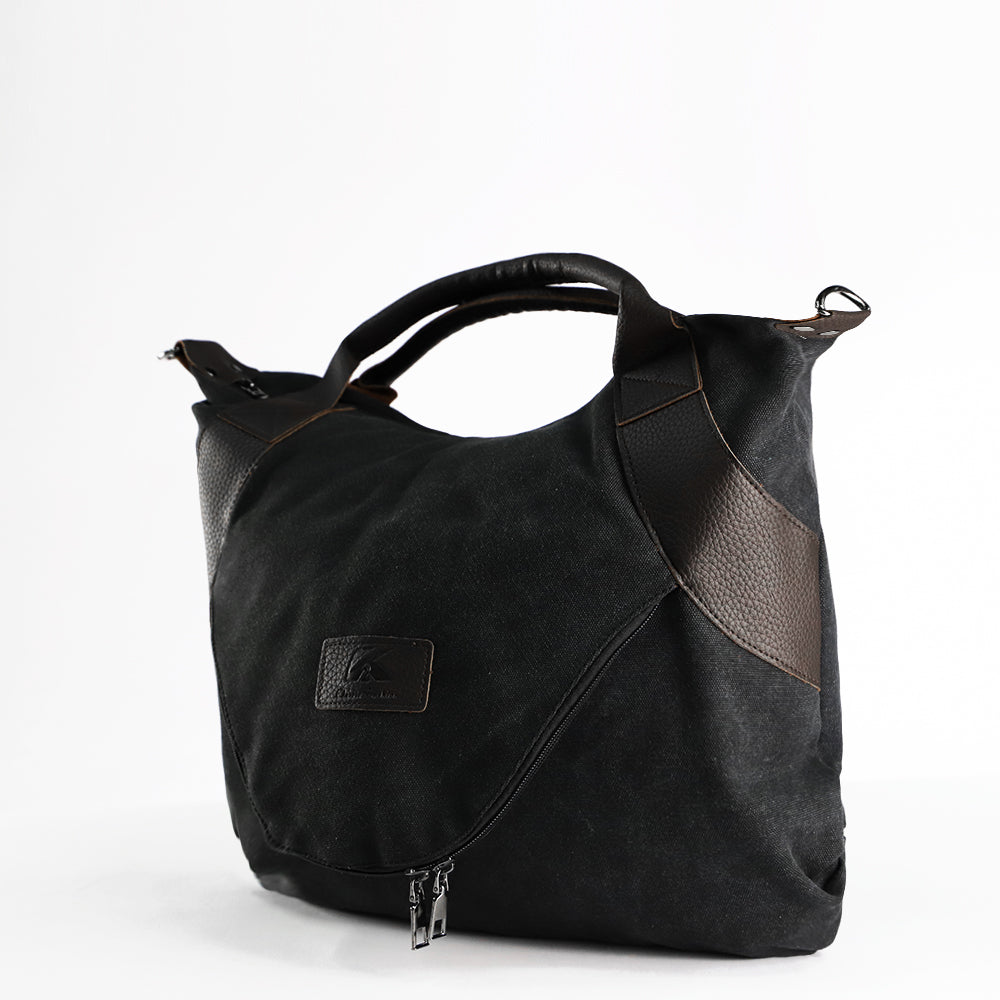 Black canvas shoulder bag with brown side panel, top handles, and front zipper pocket