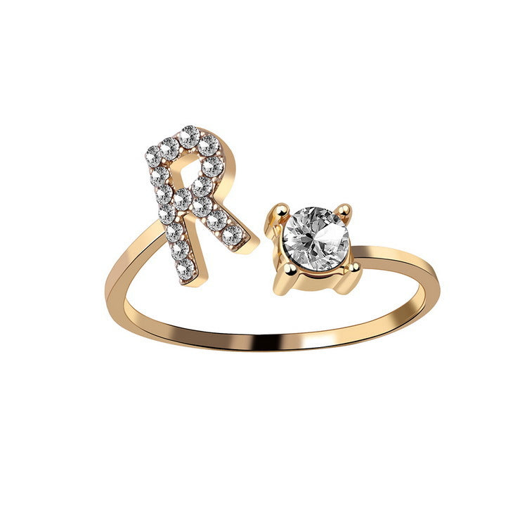 Adjustable initial letter ring with crystal letter detail and round center stone, gold-tone