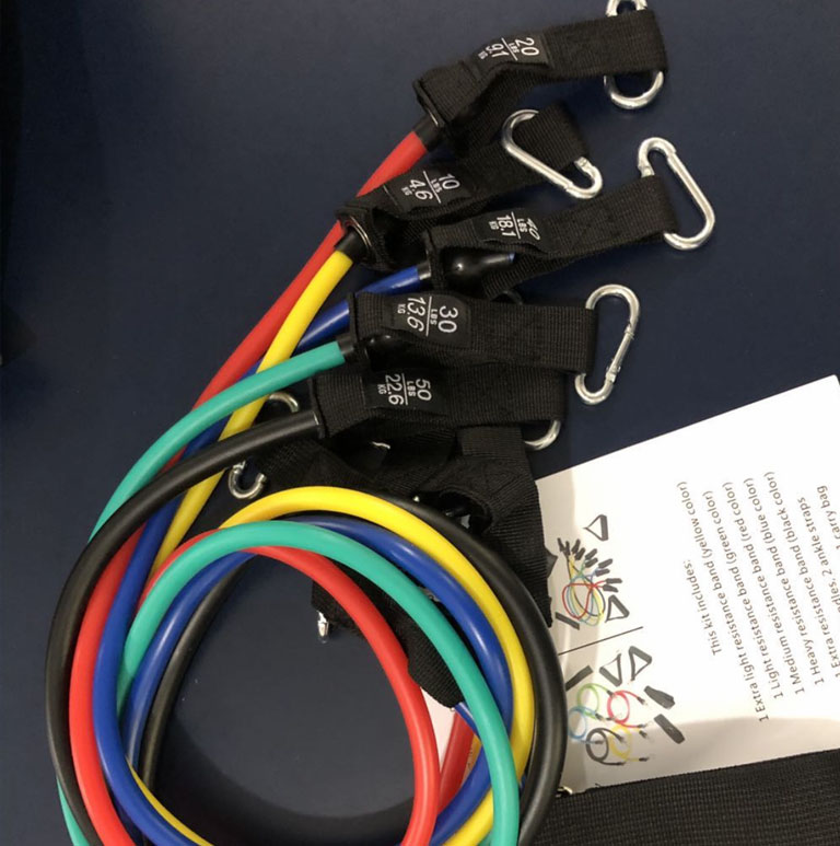 Resistance rope bands with black webbing straps and metal carabiner clips, plus booklet