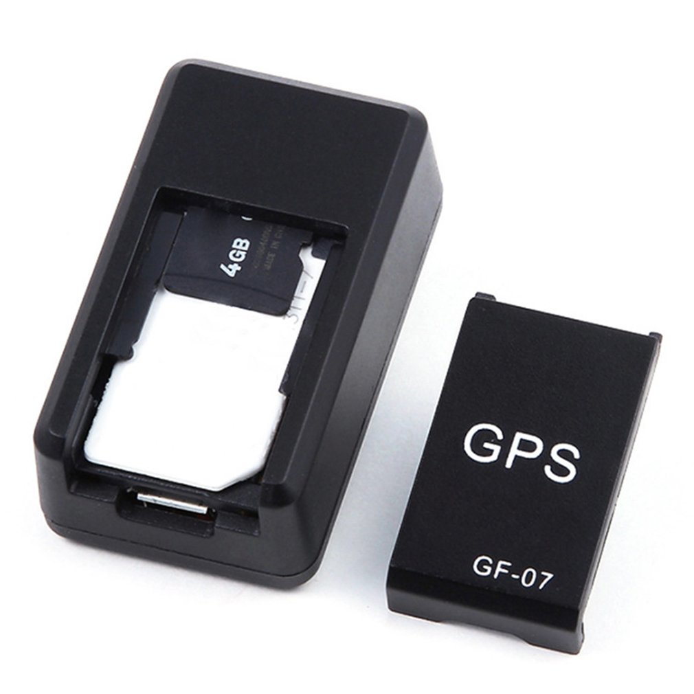 Mini GPS tracker showing microSD card inside and spare GPS cover