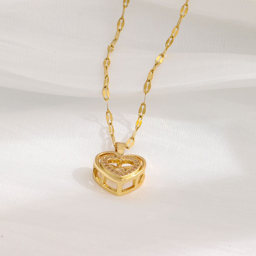 Gold-toned double-layer heart pendant necklace with rhinestone center on linked chain