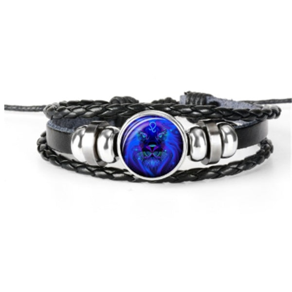 Braided leather-look bracelet with bright blue round zodiac charm and silver-toned metal bands.