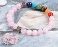 Pink crystal beaded bracelet with multicolor bead section and round rose quartz wire pendant