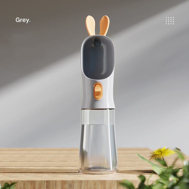 Pet water travel bottle with bunny-ear lid in grey; clear water chamber