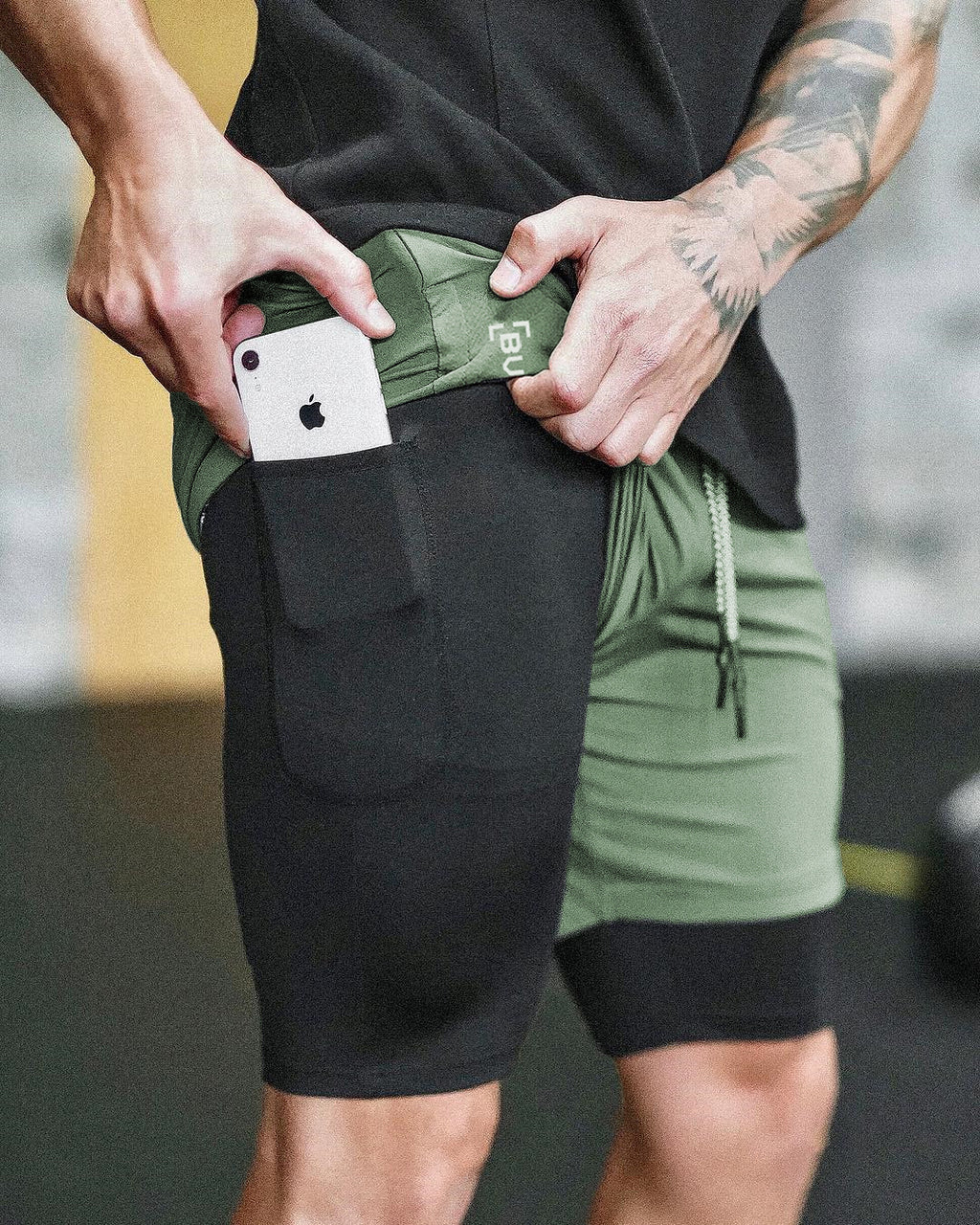 Compression shorts with phone pocket, dark green with black pocket pouch, drawstring