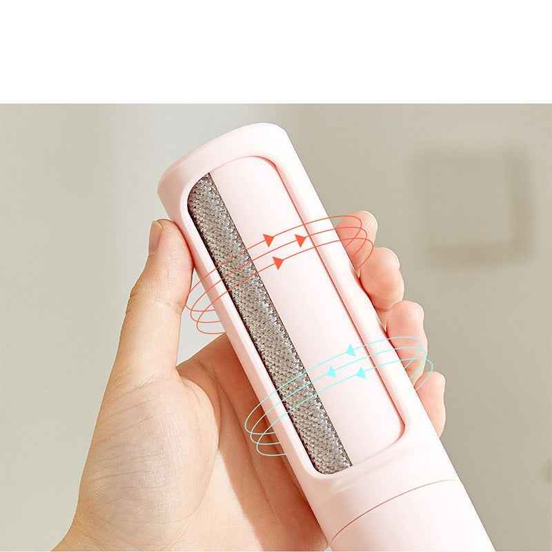 Pet hair remover lint roller brush with dark bristle head, held in hand