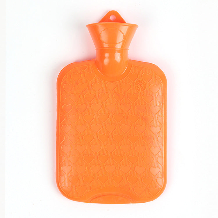Orange hot water bottle with textured heart pattern and neck stopper