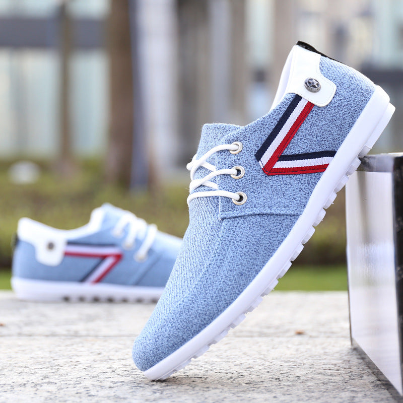Light blue canvas lace-up shoe with white sole and tricolor side panel