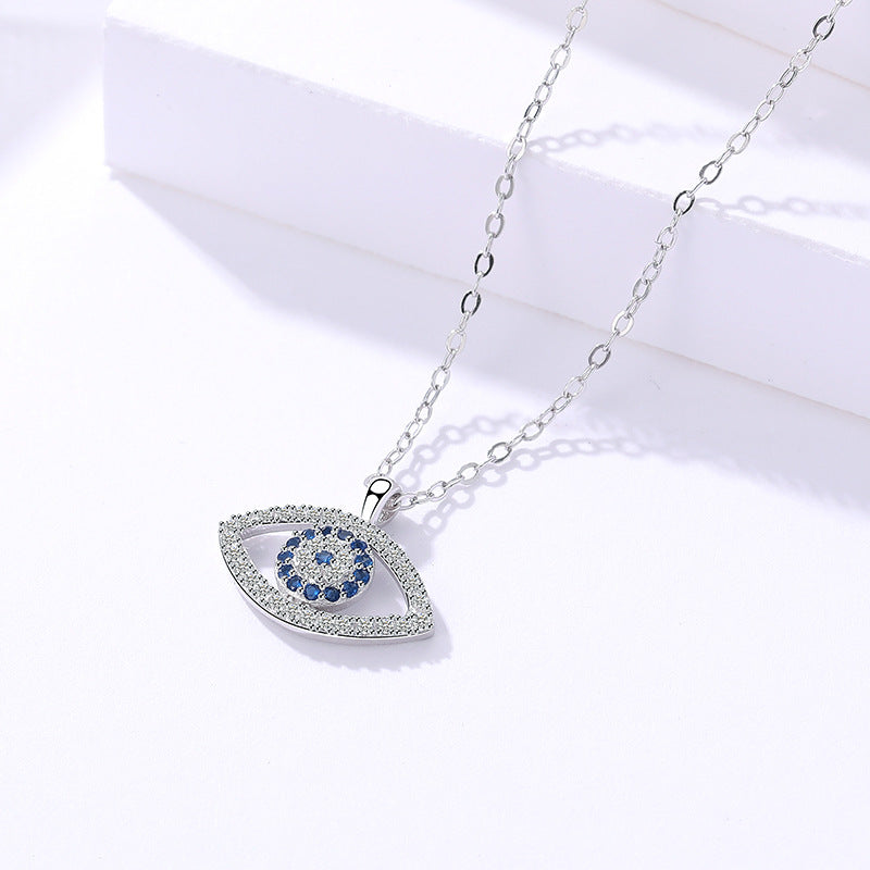 Sterling silver evil eye pendant necklace with blue eye detail on pavé-style border