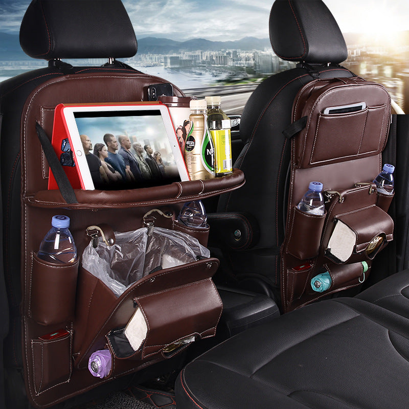 Brown PU leather car seat back storage organizer with tray, bottle pockets, and hanging panels