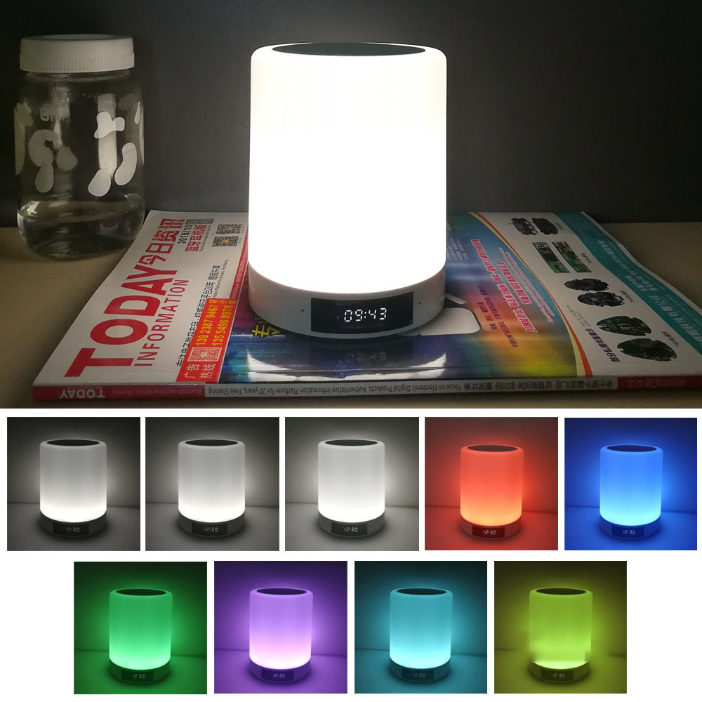 Rechargeable night light speaker glowing white on books with digital clock screen