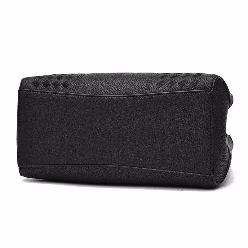Black handbag with quilted texture and structured rectangular shape