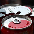 Can sealer tool with red magnet lid and pull tab on soda can top