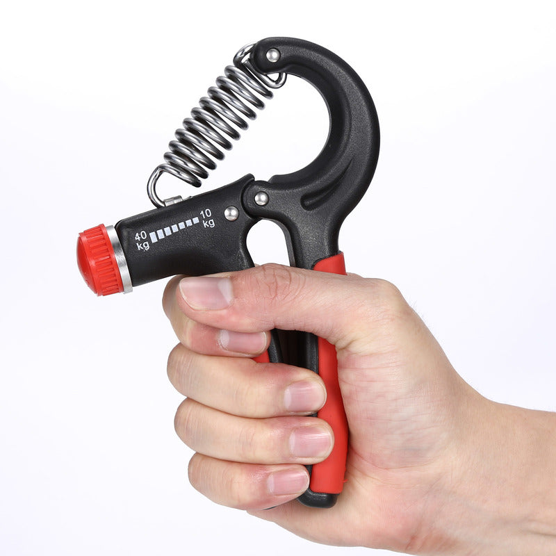 Finger exerciser hand grip in black with red handles, held in a hand for squeezing