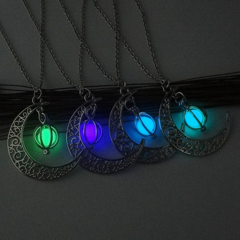 Silver crescent moon pendant necklace set with glowing green, blue, and teal stones