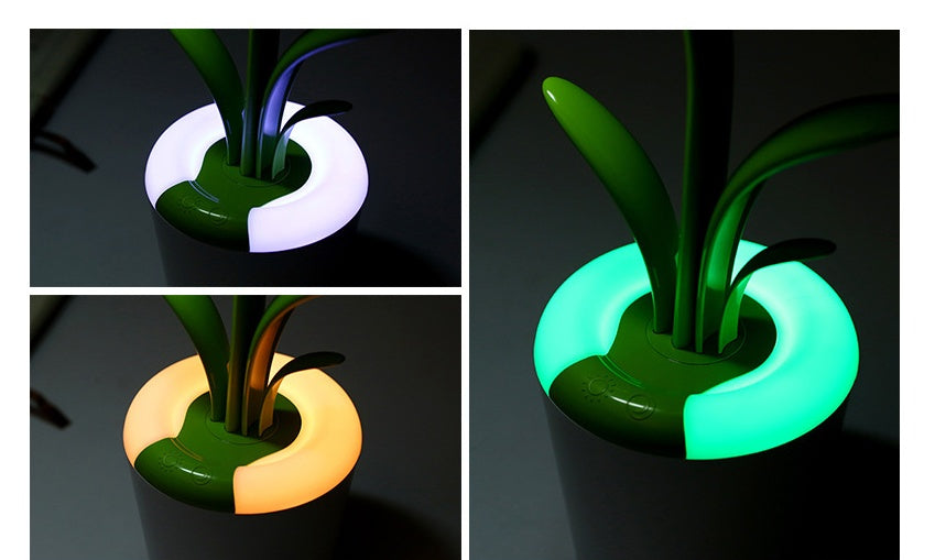 LED table lamp with green glowing base and multicolor illuminated stem lights