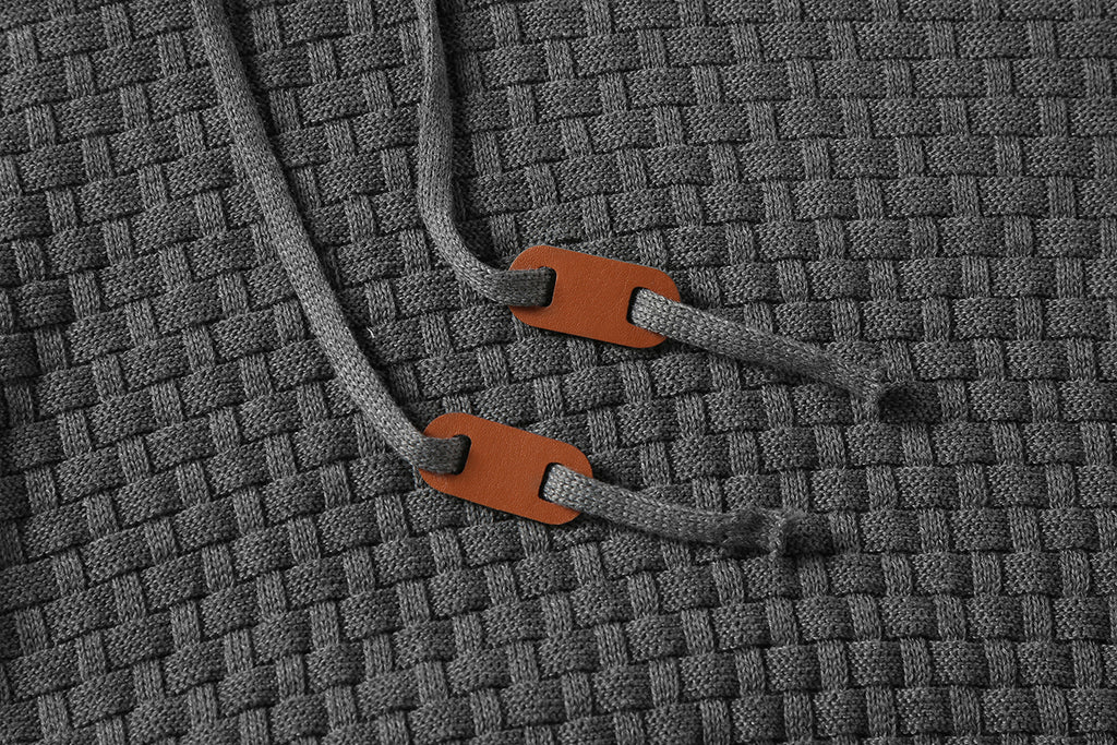 Men's hoodie sweater, gray textured knit close-up of drawcord tips and hood edge