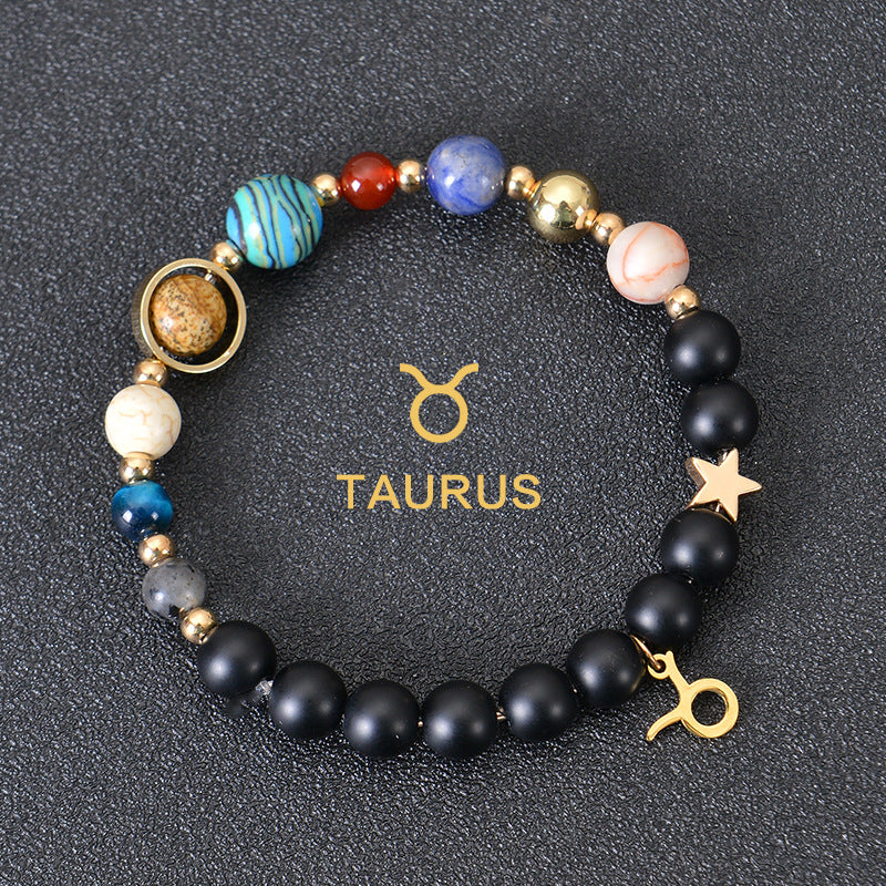 Taurus zodiac beaded bracelet with black matte beads, colorful stone beads, and gold star charm