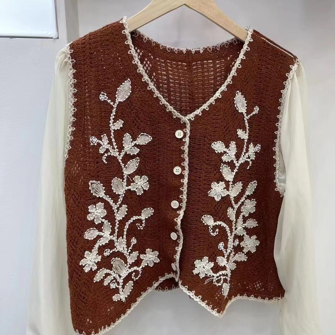 Maroon V-neck embroidered sleeveless top with floral vine motifs and button front