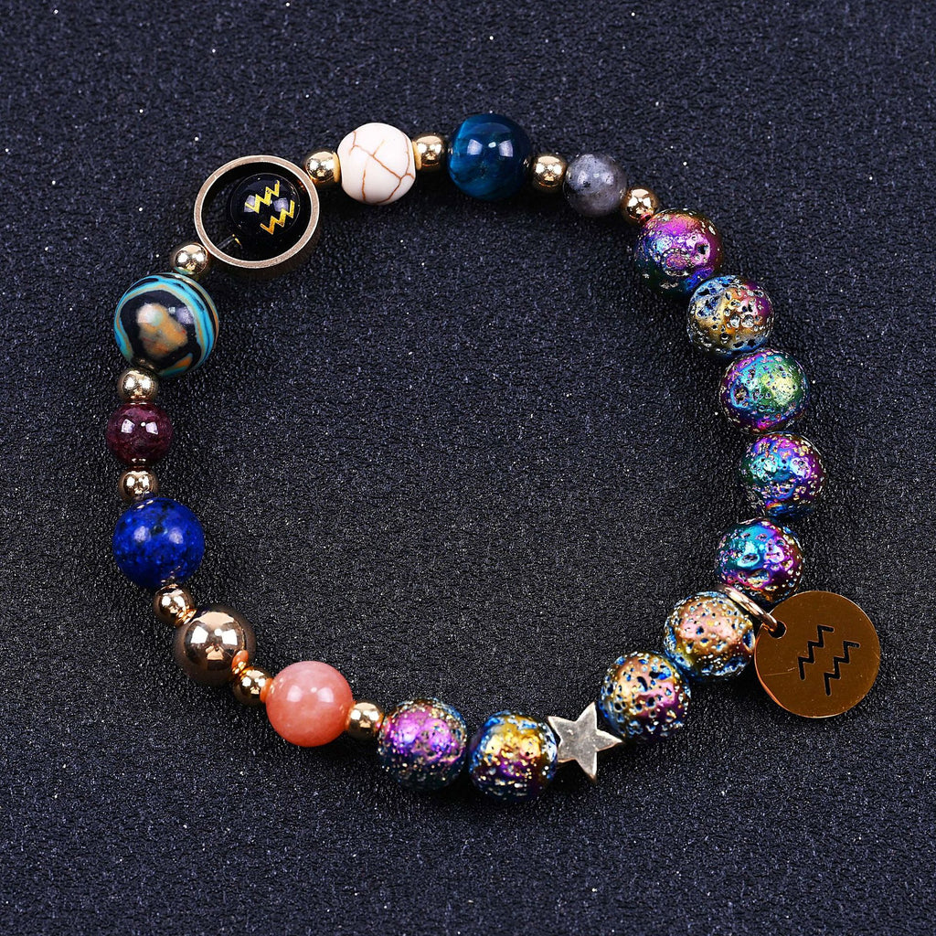 Beaded bracelet with blue, purple and pink stones, star charm, zodiac disc and lobster clasp.