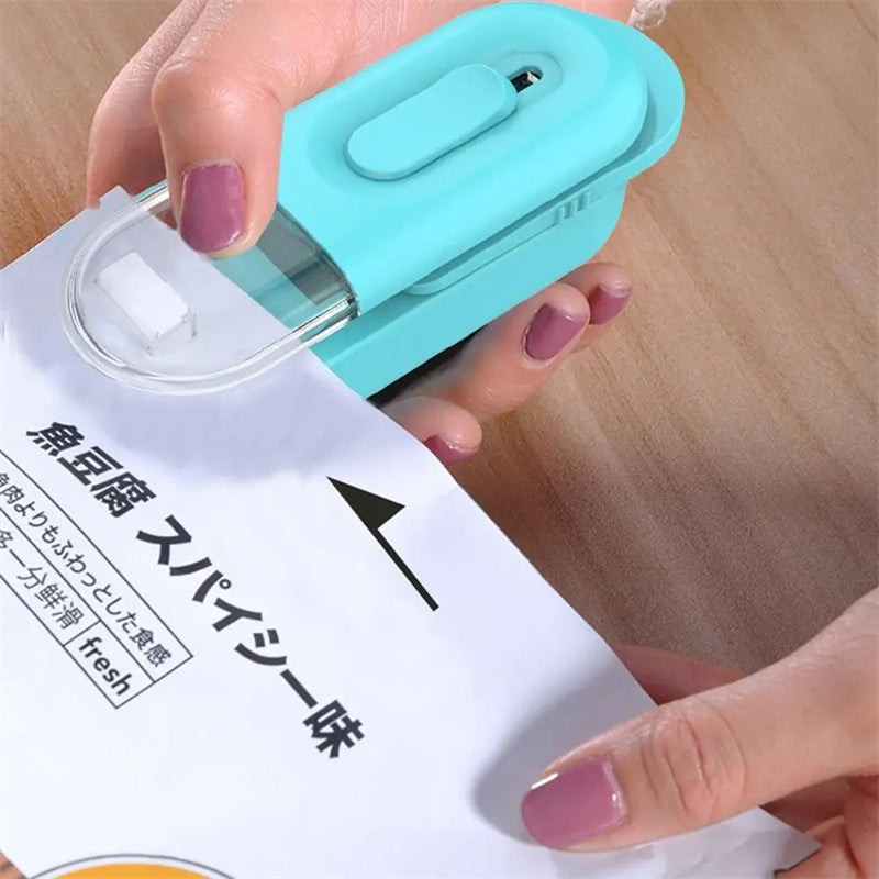 Mini bag sealer heat sealer tool in light teal with transparent sealing strip