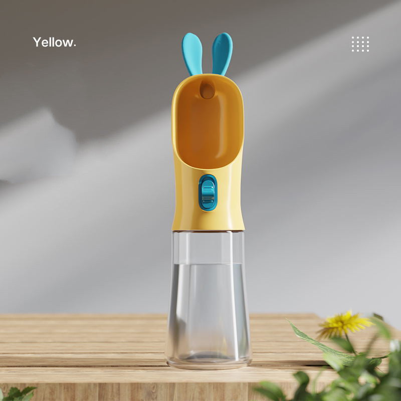 Pet water travel bottle with yellow lid and blue bunny ears; clear water chamber
