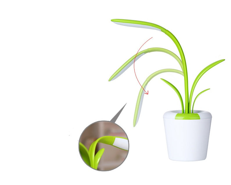 LED table lamp with green glowing plant stems and white pot