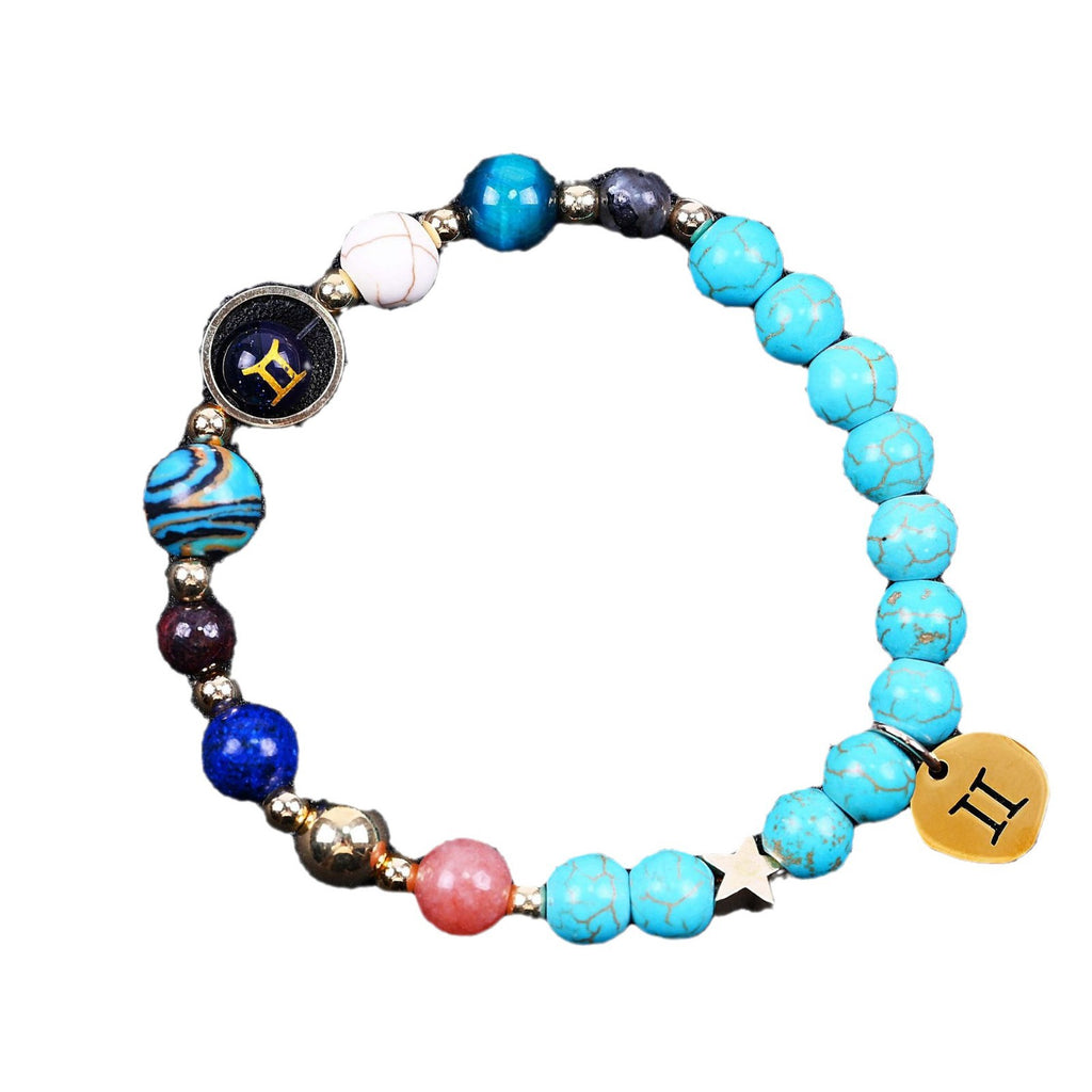 Turquoise beaded bracelet with mixed beads and zodiac charm disks, including a star accent