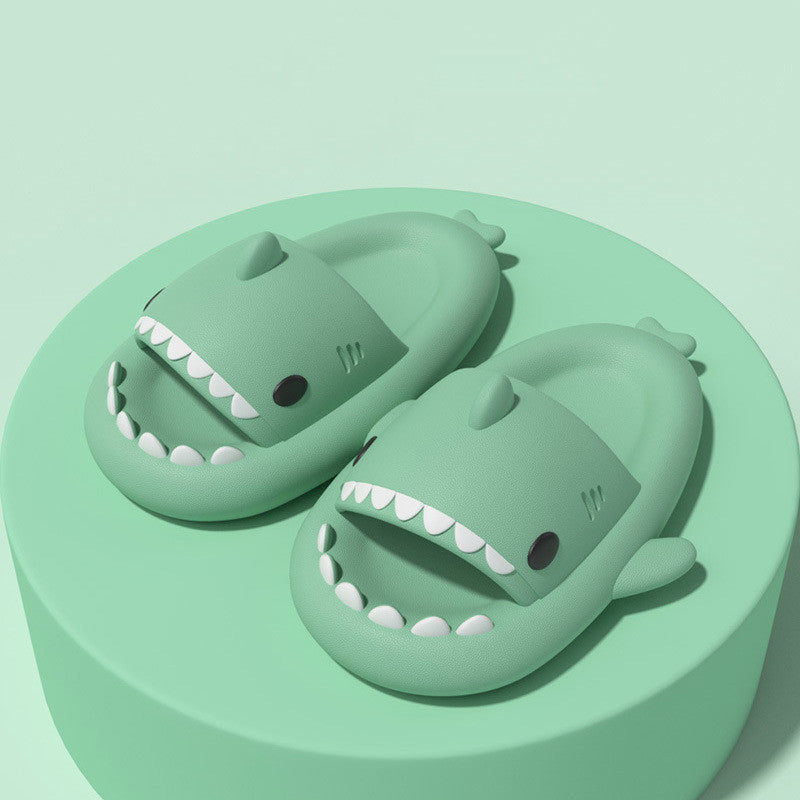 Cartoon shark slippers pair in light green, cushioned slides with smiling mouth