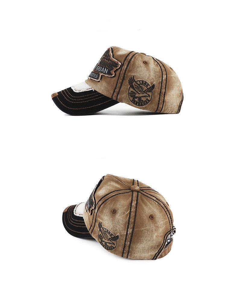 Baseball cap in tan and dark tones; stitched GUAN patch and side emblem