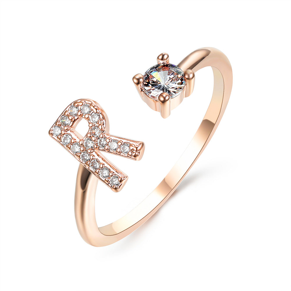 Adjustable initial letter ring with round crystal and pavé stones, rose gold tone band