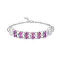 Sterling silver bracelet with purple stones and decorative end charms