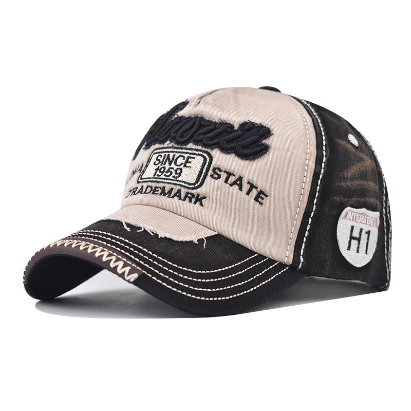 Tan baseball cap with dark side panel, curved brim, and embroidered state patch