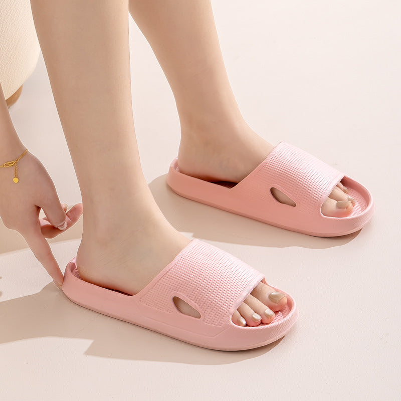 Pink slide slippers on feet with textured upper and thick sole