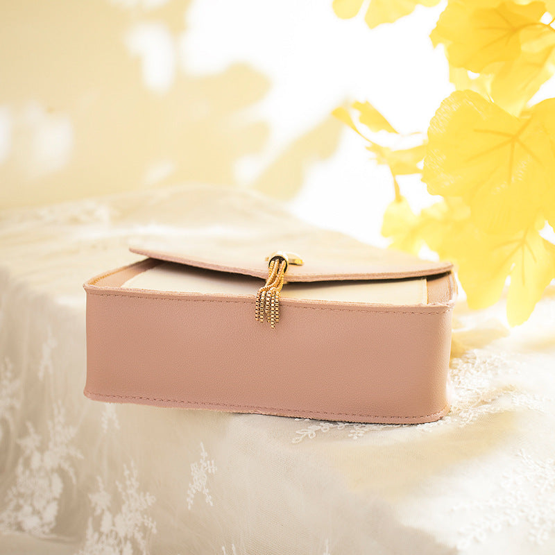 Small messenger bag, blush pink, flap closure with tassel charm, gold chain strap