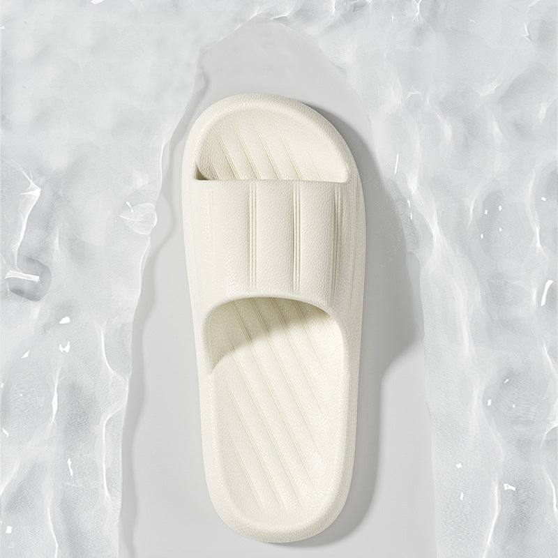 White slide slipper with striped strap and ribbed footbed on thick sole