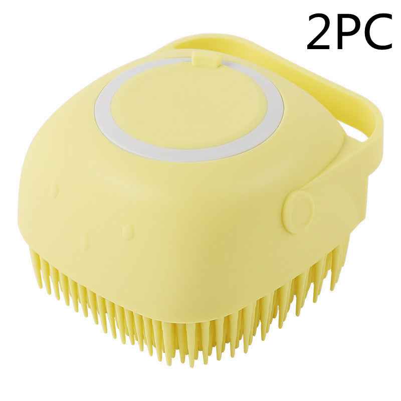Yellow silicone pet grooming brush with oval massage pad and side carry handle