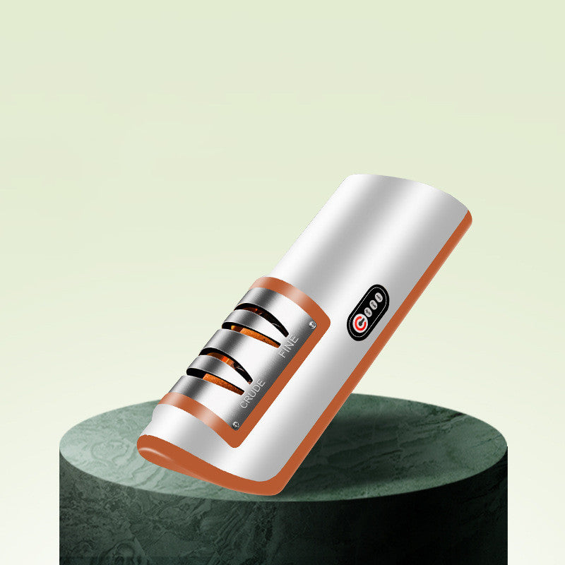 USB rechargeable electric knife sharpener with white body and orange side accents, on stand